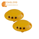 Yellow plastic round road stud with cat eye